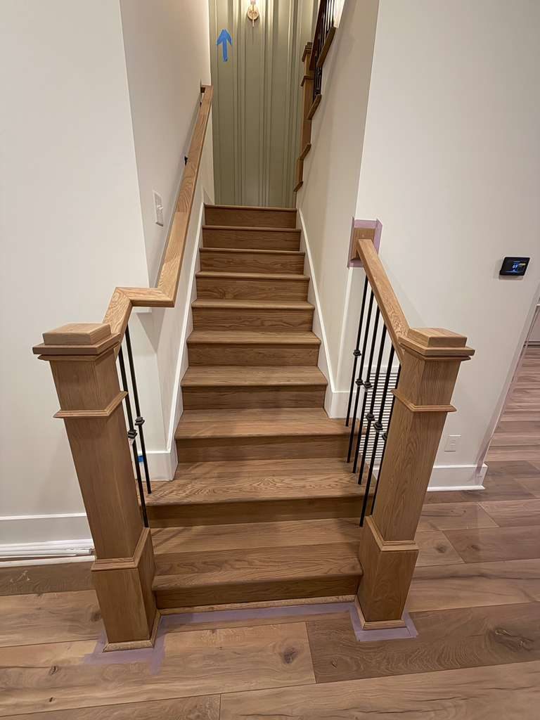 Coastal hardwood floor installation with waterfront view