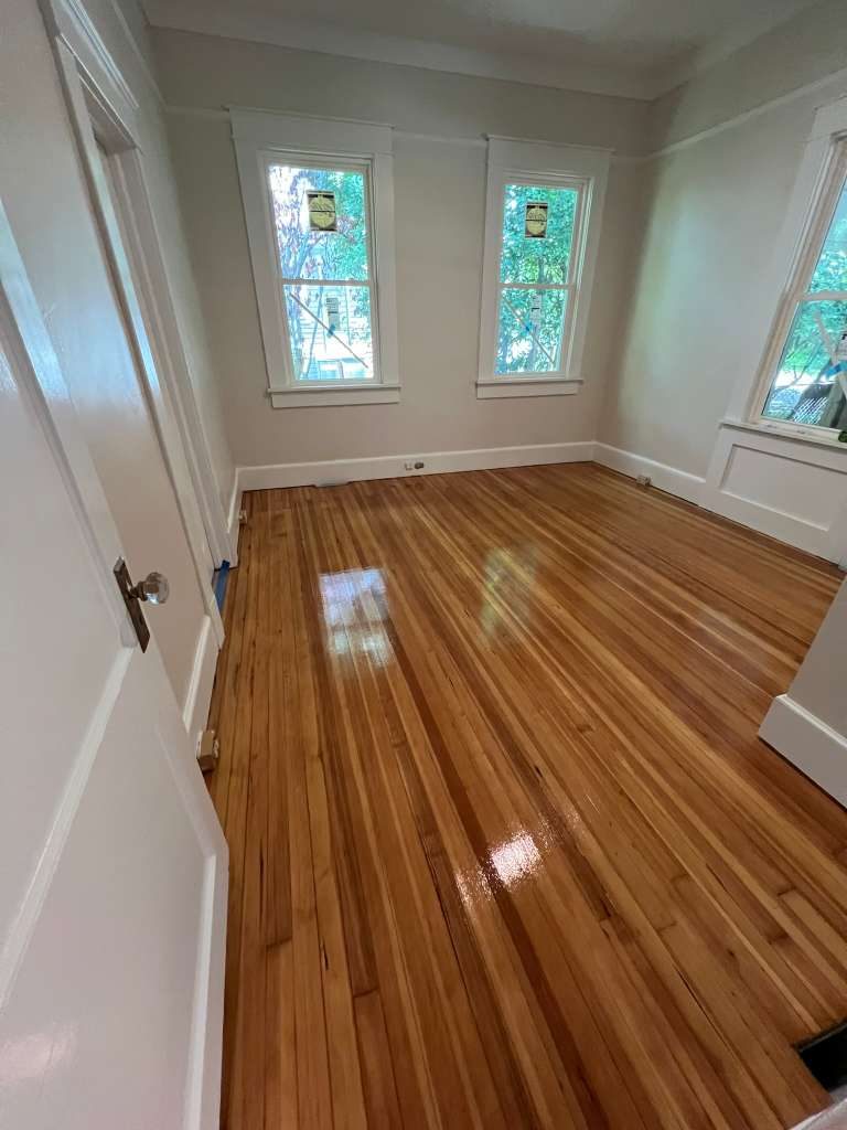 Exotic wood floor restoration with chandelier