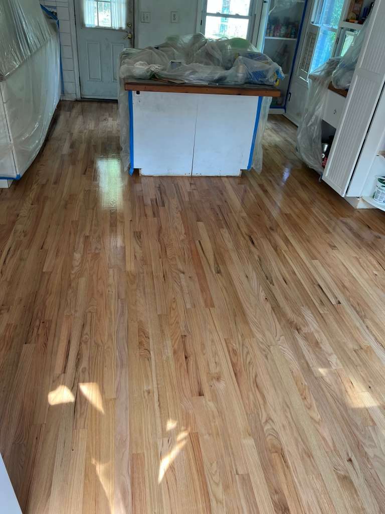 Heart pine living room floor with stone fireplace